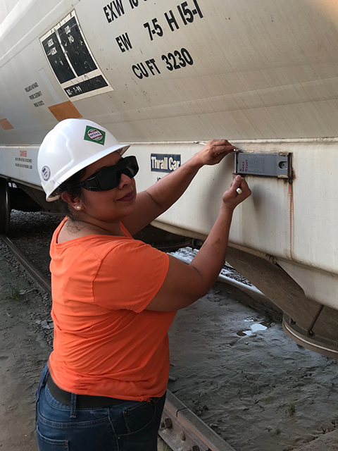 Diana Duke of Railcar Field Services working on train